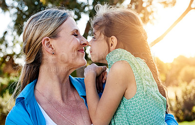 Buy stock photo Shot of an affectionate mother and daughter spending time together outdoors