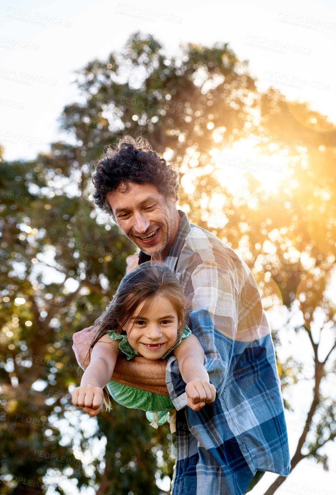 Buy stock photo Father, portrait and child playing plane outdoor with happiness for summer or holiday as family. Man, girl and smile by tree in nature with fun for freedom, love and fun together as superhero flying