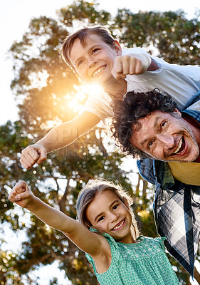 Buy stock photo Portrait of a happy father spending time with his son and daughter outdoors