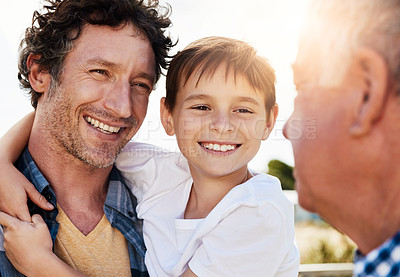 Buy stock photo Shot of a young boy spending time with his father and grandfather outdoors