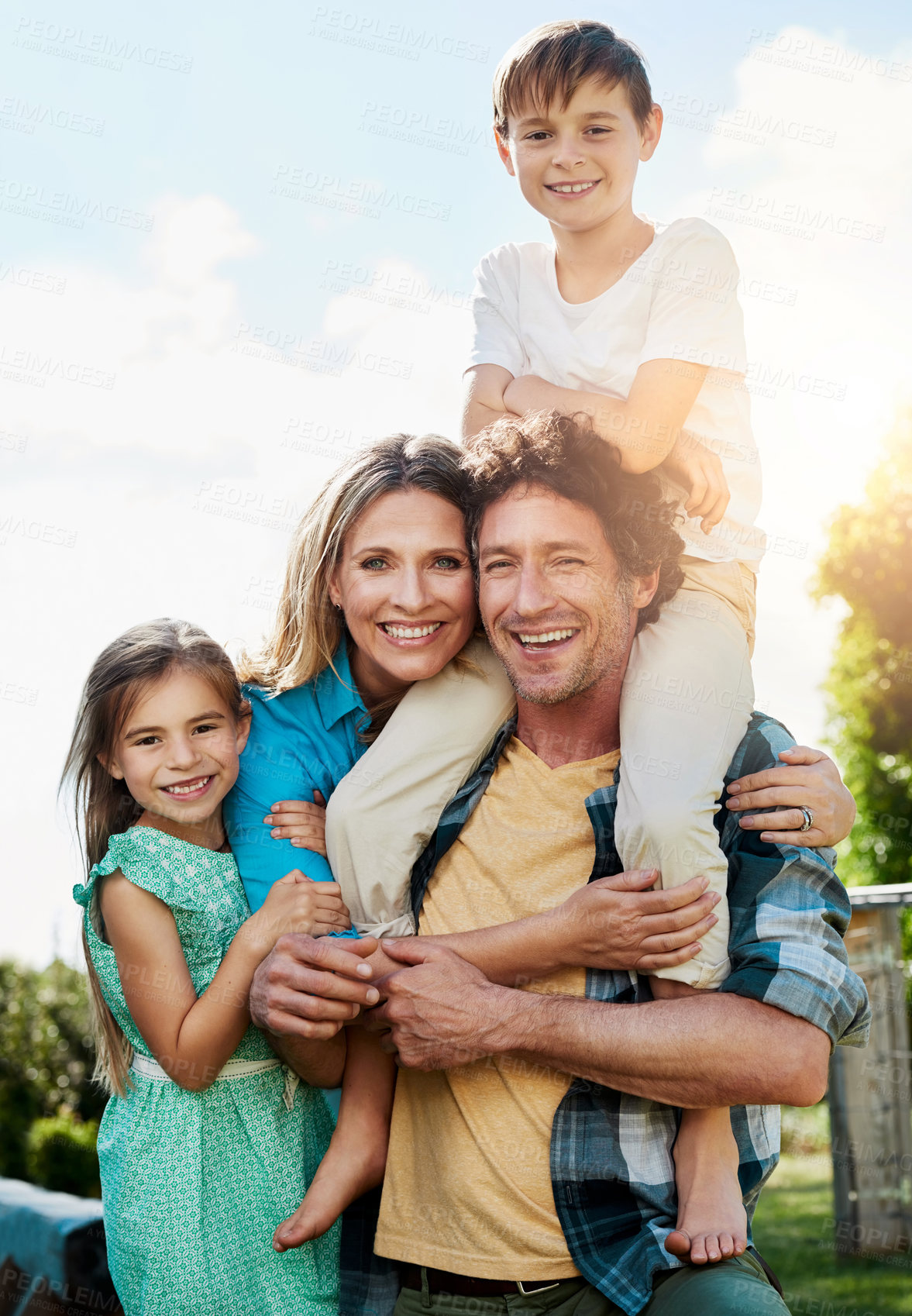 Buy stock photo Family, portrait and smile with piggyback at park for weekend adventure, bonding and support. Summer, love and children with parents in nature for holiday, vacation and happiness on fathers day