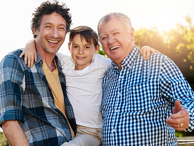 Buy stock photo Portrait of a young boy spending time with his father and grandfather outdoors