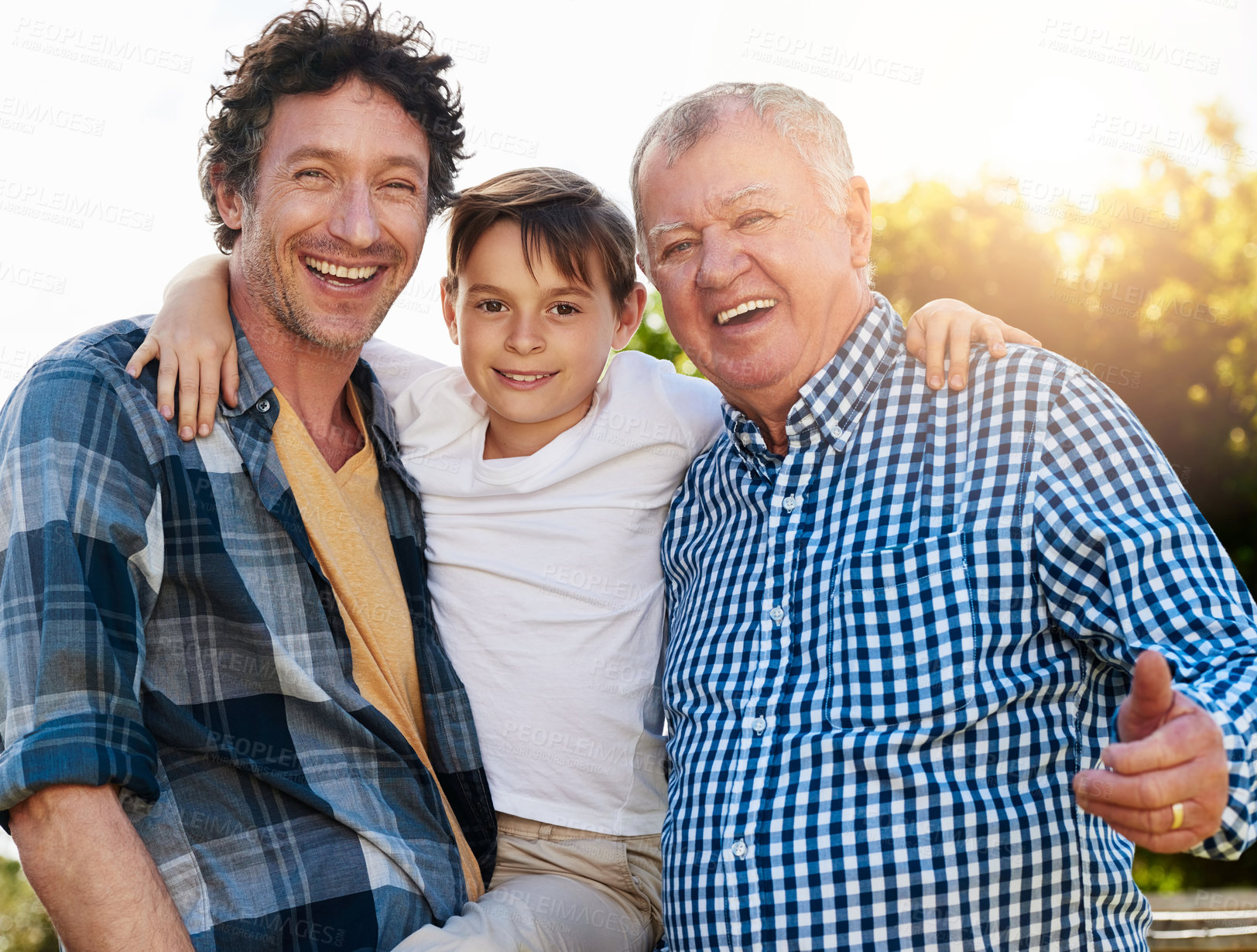 Buy stock photo Grandfather, father and boy with portrait in outdoor park for happiness, support and bonding together. Lens flare, family and generations of men with smile for legacy, morning walk or weekend break