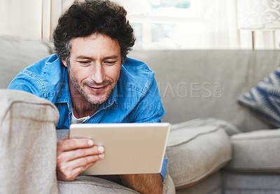 Buy stock photo Man, relax and tablet internet on sofa for digital contact, social media or movie app. Male person, streaming film and online shop connection or connectivity fun for comfort, weekend joy in house