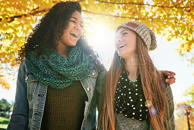 Buy stock photo Shot of two young friends enjoying a day at the park together