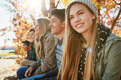 Buy stock photo Happy, row and friends outdoor in park for relaxing day on summer vacation of semester break, together and bonding. Group, teenagers and trees in garden on holiday in New Zealand and lens flare.