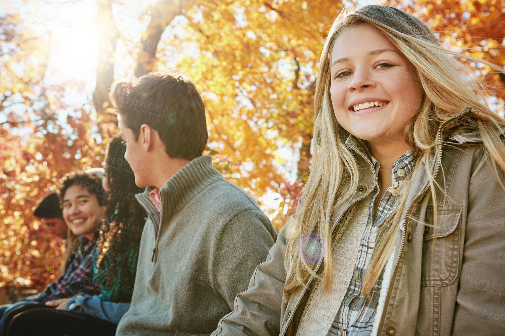 Buy stock photo Nature, adventure and group of teenagers on vacation, or weekend trip together in Autumn countryside. Smile, travel and young friends on holiday sit in outdoor garden, park or field in New Zealand.