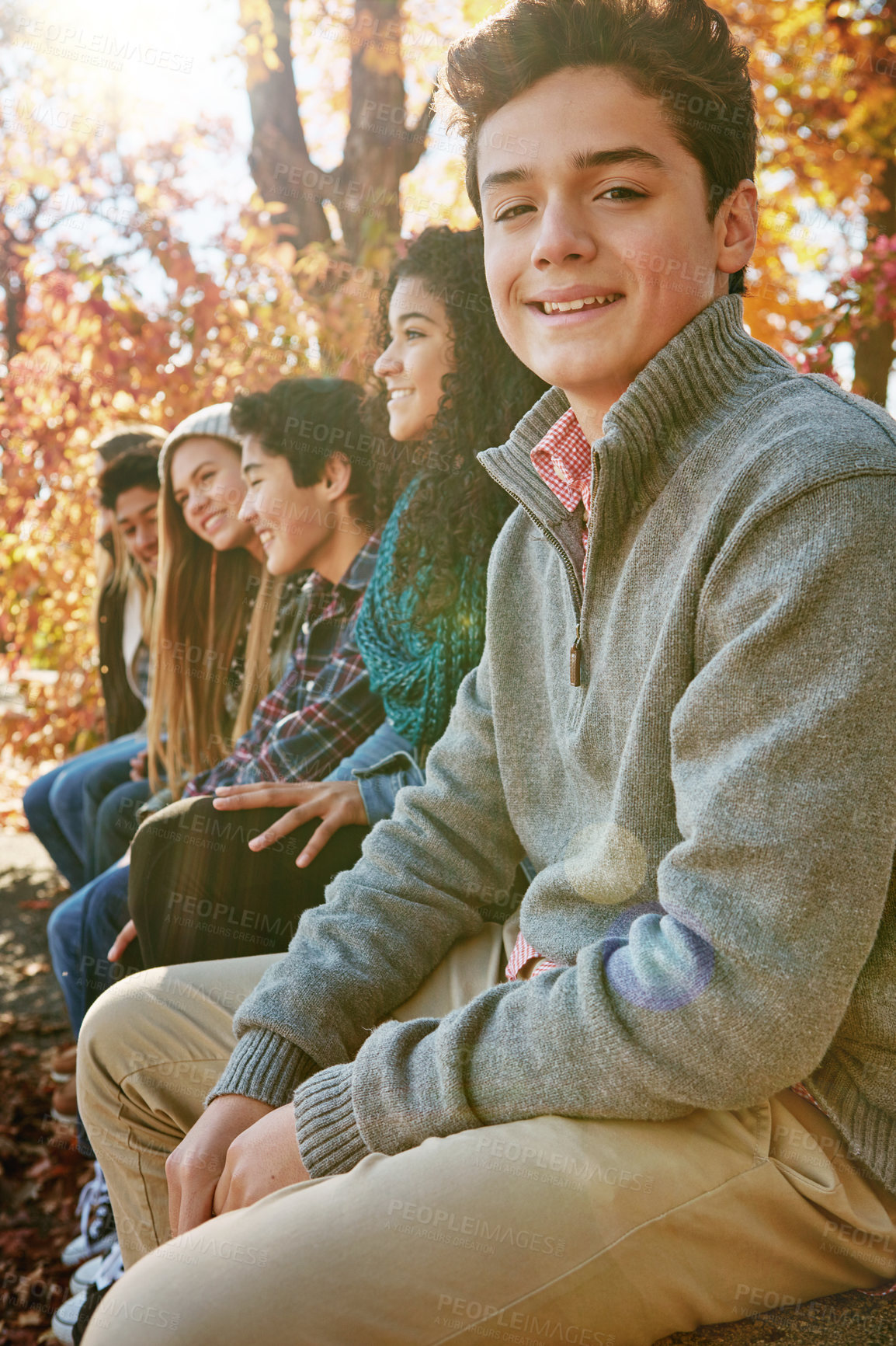 Buy stock photo Boy, friends and park with relax or portrait with casual, trees in nature with smile. Group, people and young in portrait or happy with diversity in garden for friendship, youth or wellness in Canada