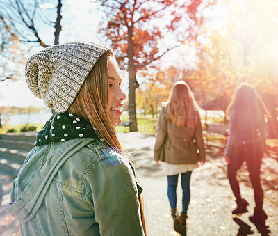 Buy stock photo Teenage girl in nature with friends, walk in park with autumn and sunshine, wellness with happiness. Youth outdoor, enjoy fresh air and bonding with smile, lens flare with adventure or travel