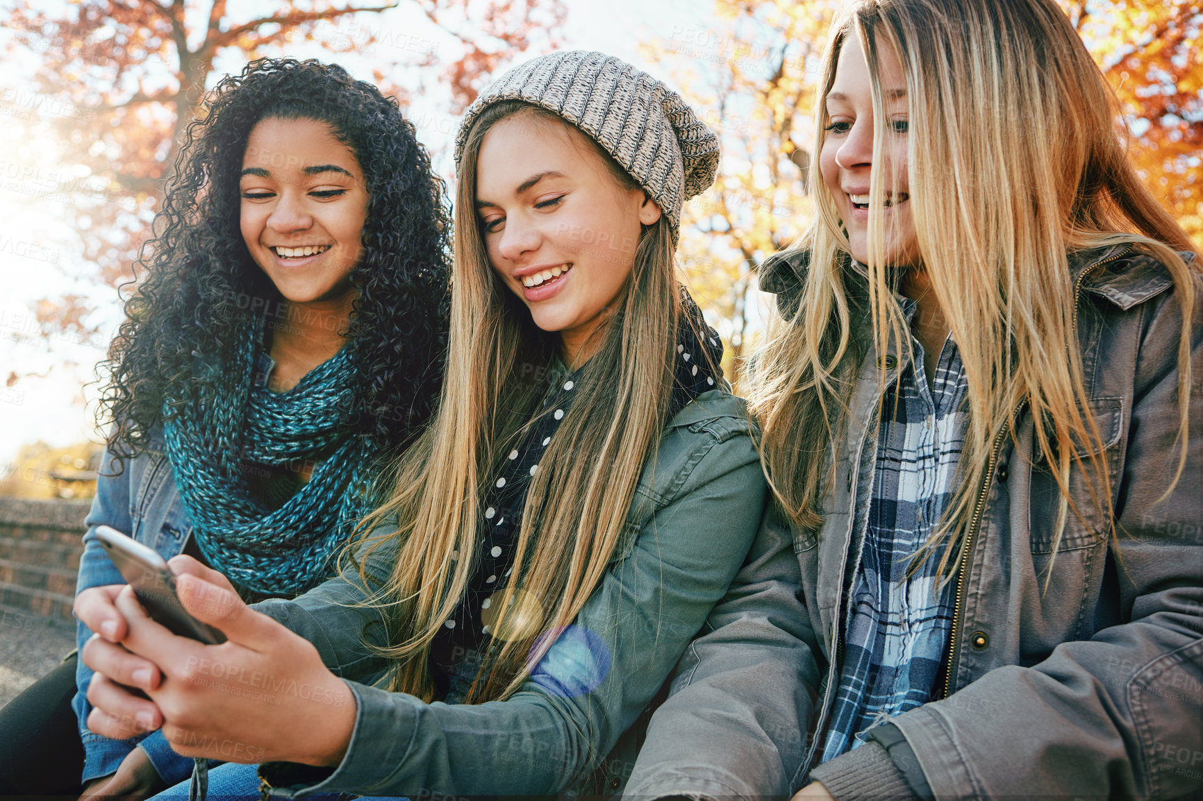 Buy stock photo Phone, social media or girl friends in park with smile together for holiday vacation bonding outdoors. Teenager, gossip or happy gen z people in nature talking, speaking or laughing at a funny meme