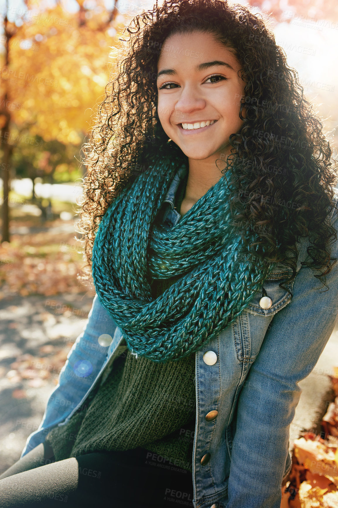 Buy stock photo Portrait of a happy teenage girl enjoying an autumn day in the park