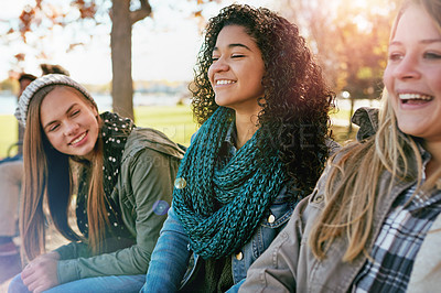 Buy stock photo Shot of a group of teenage friends enjoying an autumn day outside together