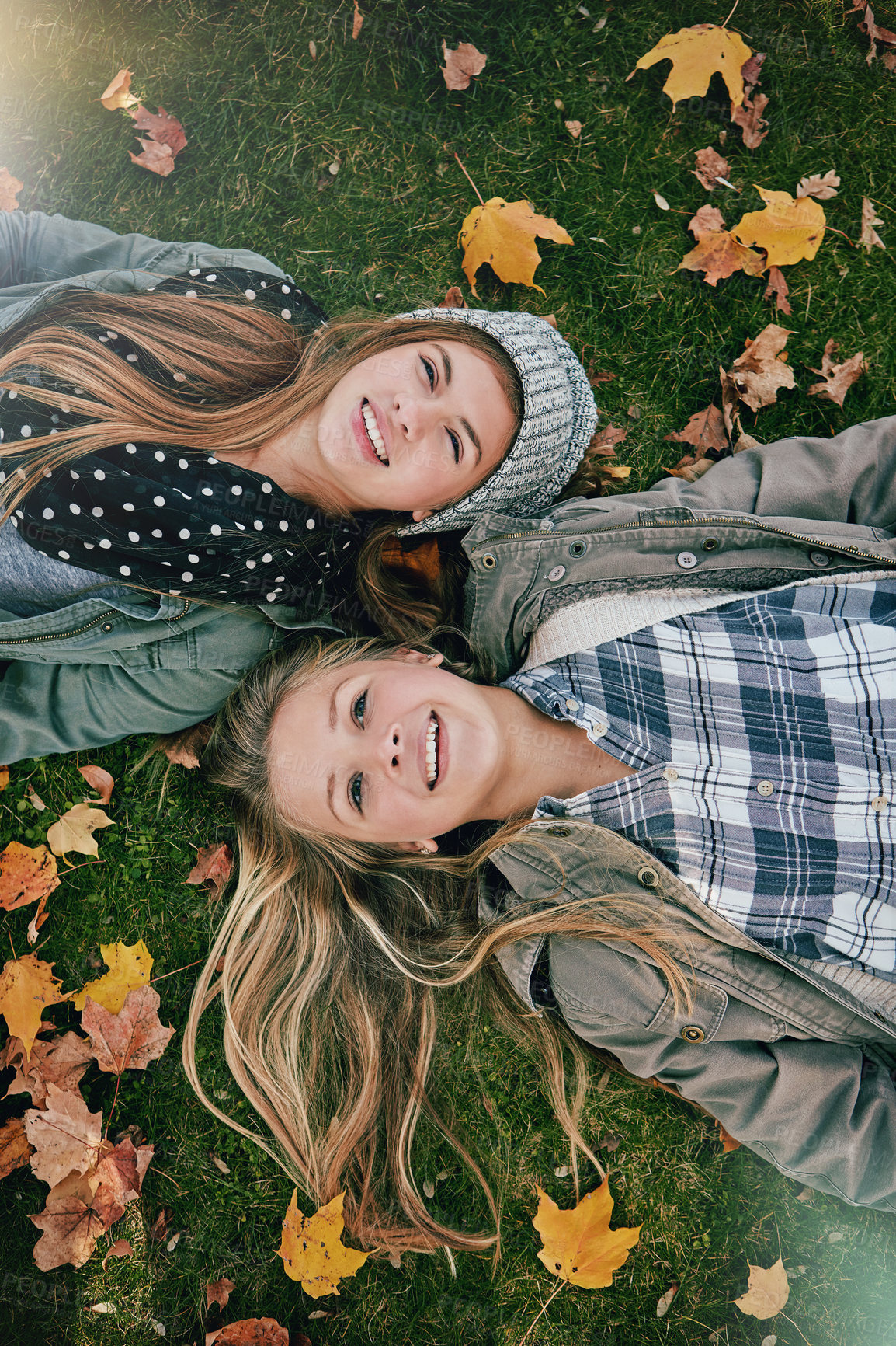 Buy stock photo Top view, friends or girls on grass for lying, relaxing and bonding together in park with happiness. Nature, lawn or teenagers on summer holiday for chilling, hanging out or laugh outdoors with smile