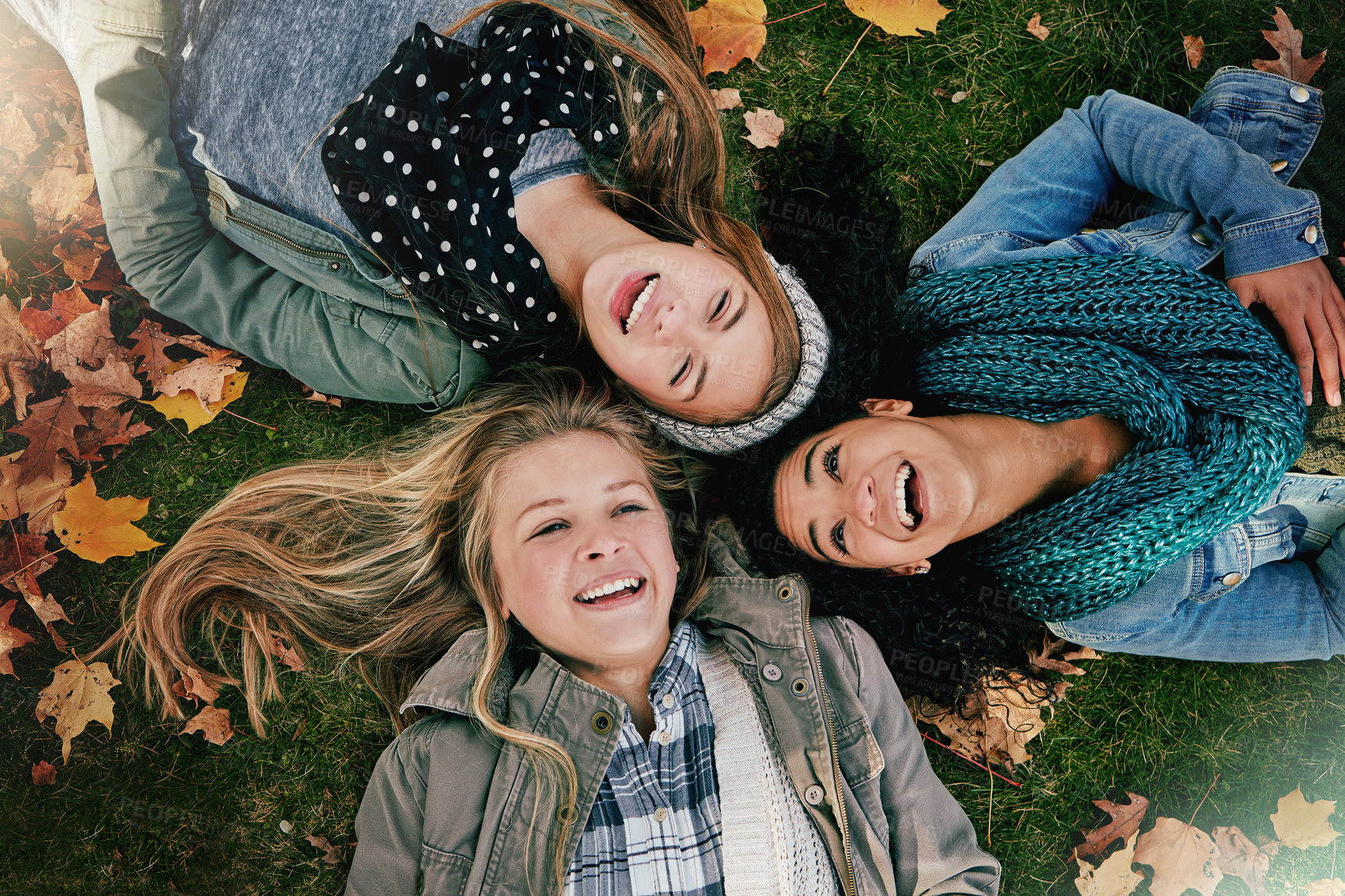 Buy stock photo Above, funny or girls on grass for lying, relaxing and bonding together in park with happiness. Nature, friends and teens on summer holiday for chilling, hanging out and laugh outdoors with smile