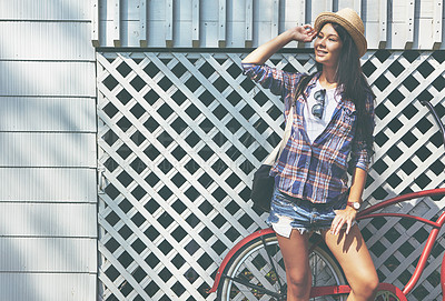 Buy stock photo Shot of a beautiful young woman riding her bike in the park