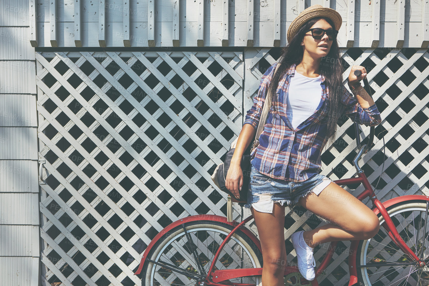 Buy stock photo Shot of a beautiful young woman riding her bike in the park