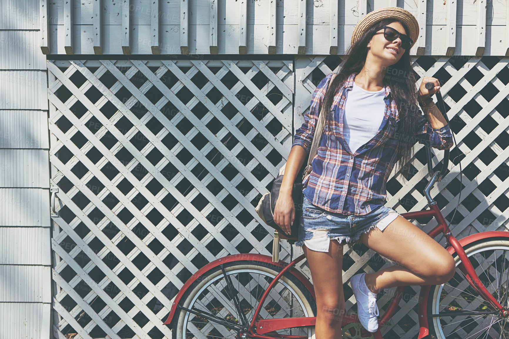 Buy stock photo Shot of a beautiful young woman riding her bike in the park