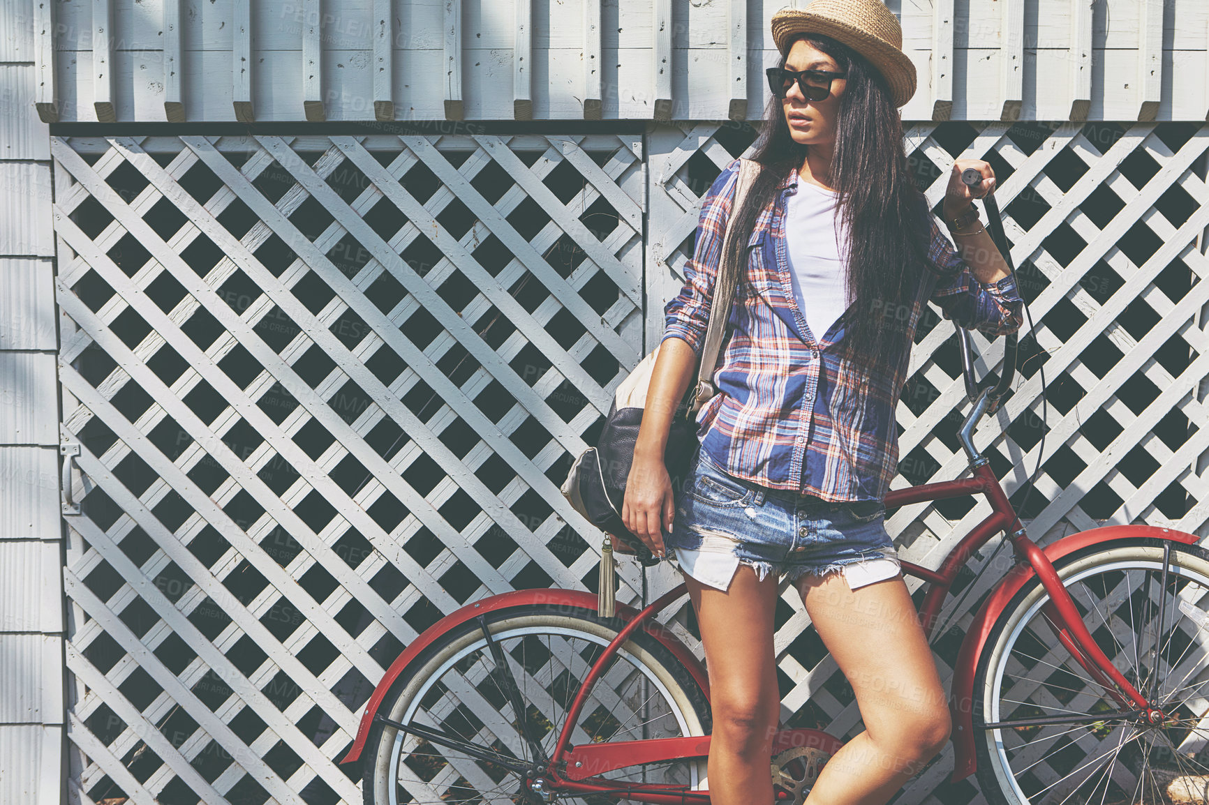 Buy stock photo Shot of a beautiful young woman riding her bike in the park