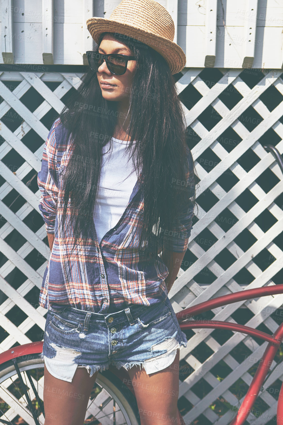 Buy stock photo Shot of a beautiful young woman riding her bike in the park