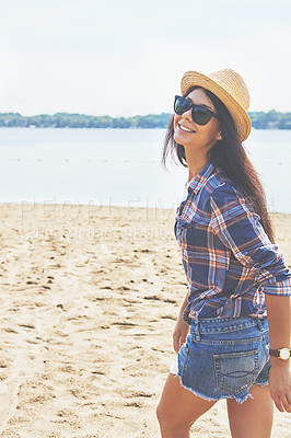 Buy stock photo Shot of an attractive young woman enjoying a day on the beach