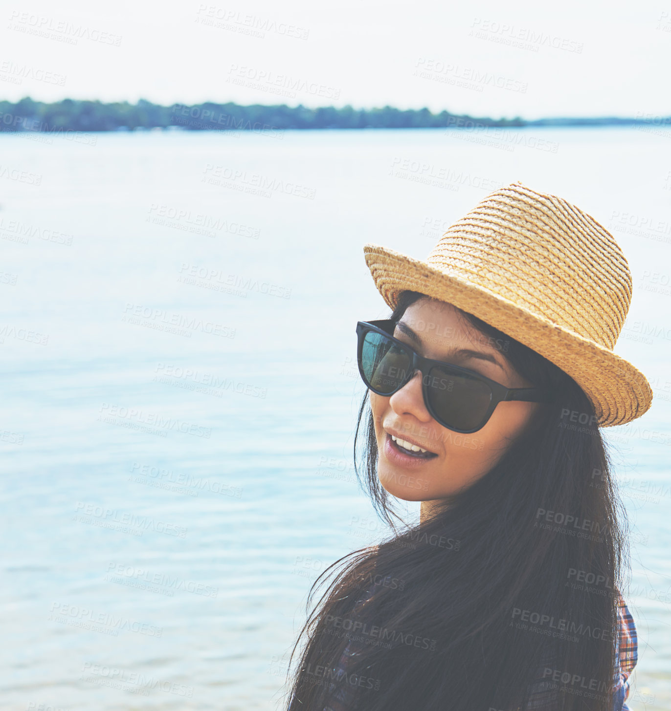 Buy stock photo Shot of an attractive young woman enjoying a day on the beach