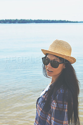 Buy stock photo Shot of an attractive young woman enjoying a day on the beach