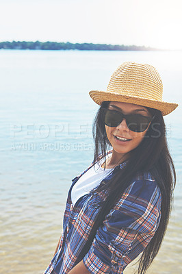 Buy stock photo Shot of an attractive young woman enjoying a day on the beach