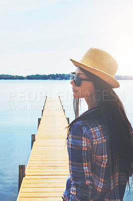 Buy stock photo Shot of an attractive young woman enjoying a day on the beach