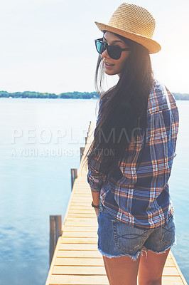 Buy stock photo Shot of an attractive young woman enjoying a day on the beach