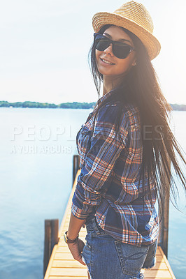 Buy stock photo Shot of an attractive young woman enjoying a day on the beach