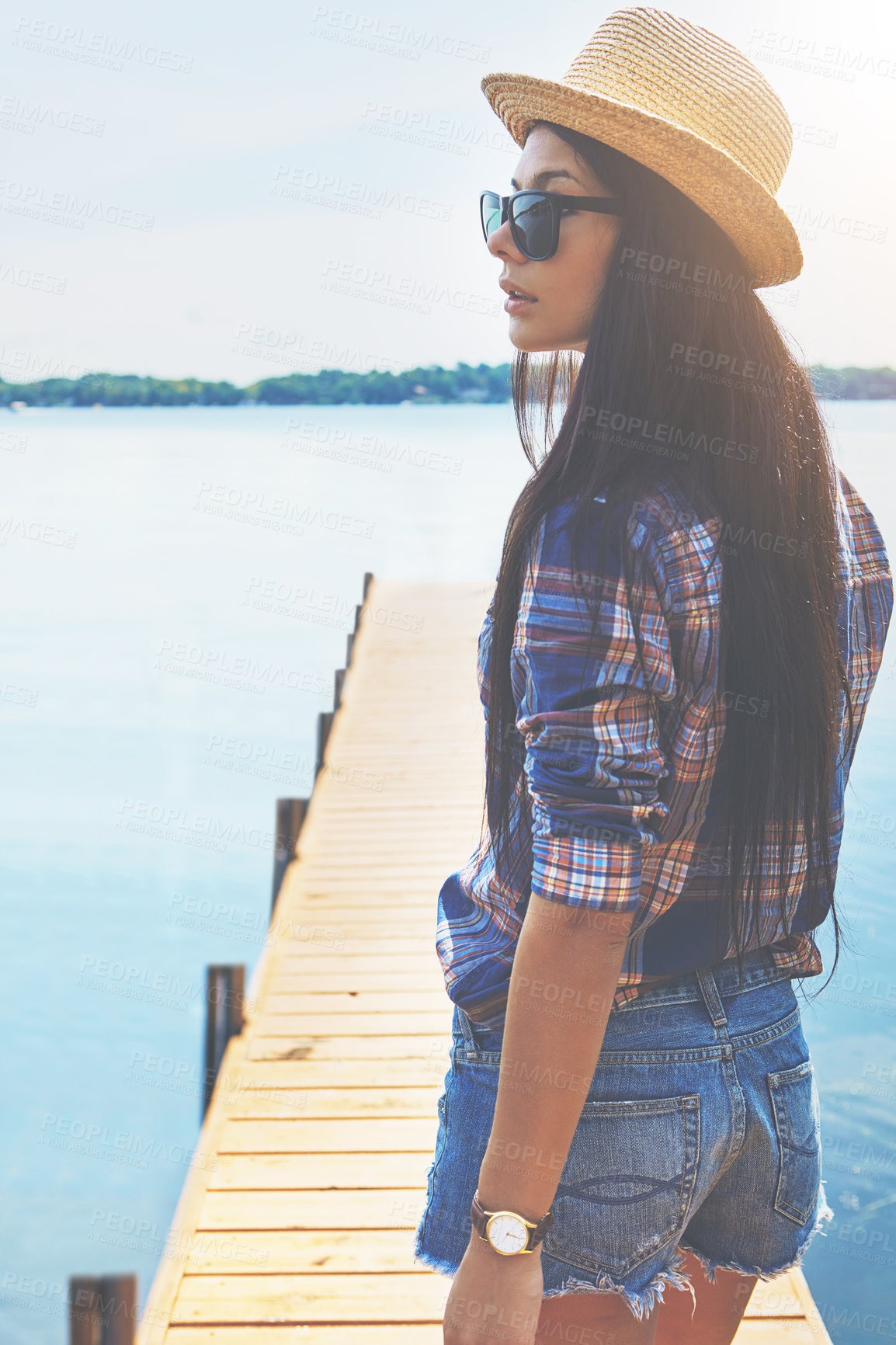 Buy stock photo Shot of an attractive young woman enjoying a day on the beach