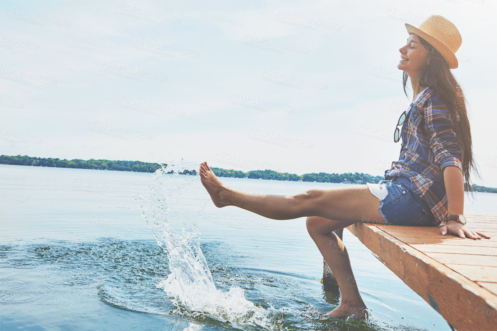 Buy stock photo Shot of an attractive young woman enjoying a day on the beach