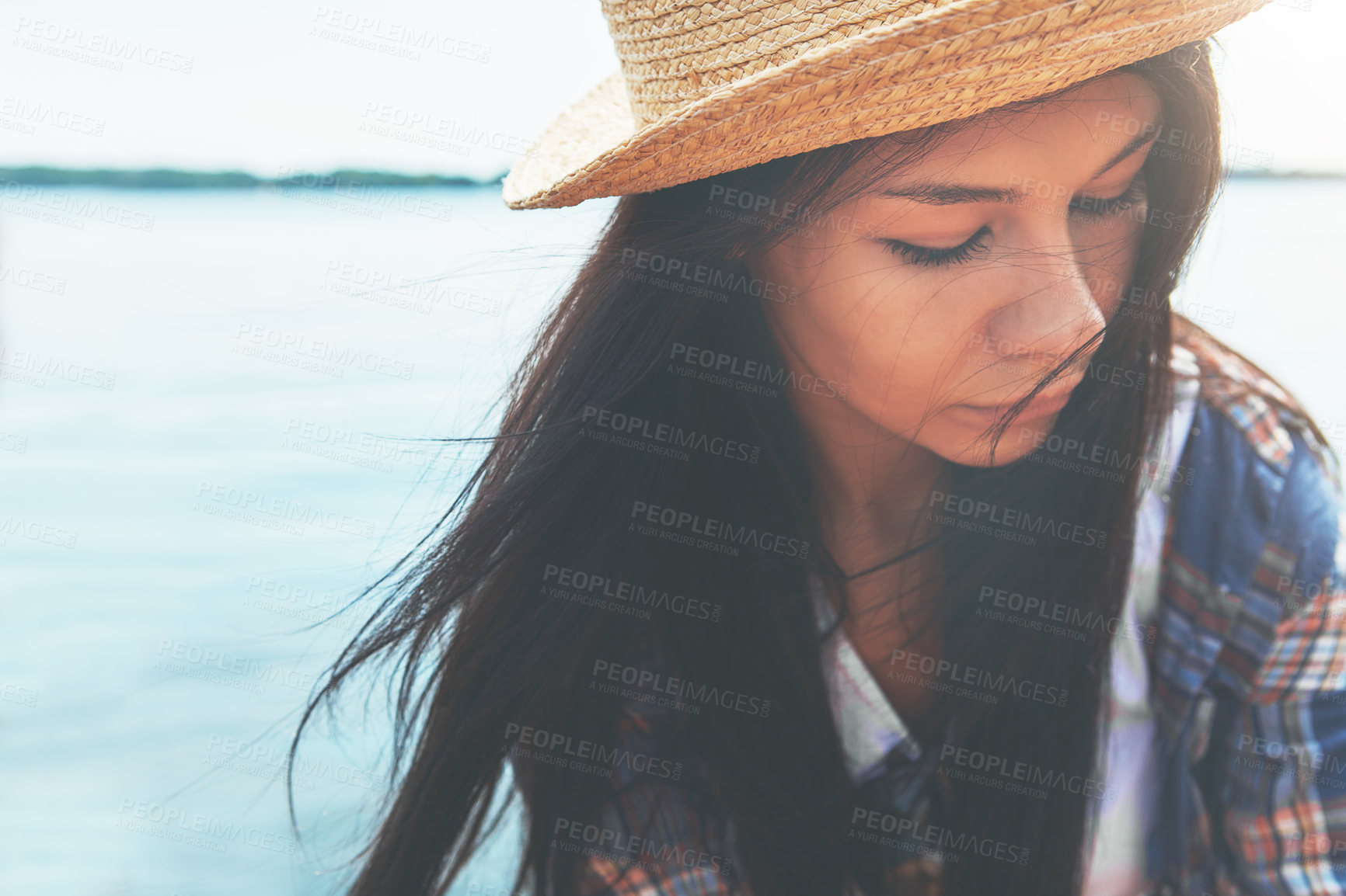 Buy stock photo Shot of an attractive young woman enjoying a day on the beach