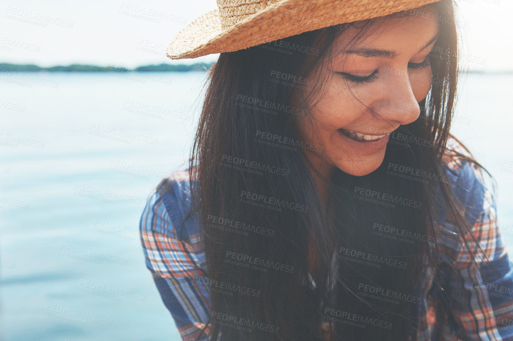 Buy stock photo Shot of an attractive young woman enjoying a day on the beach