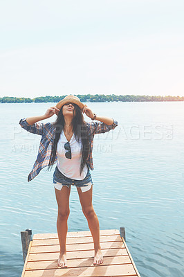 Buy stock photo Shot of an attractive young woman enjoying a day on the beach