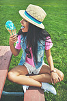 Treating herself to an ice cream in the park