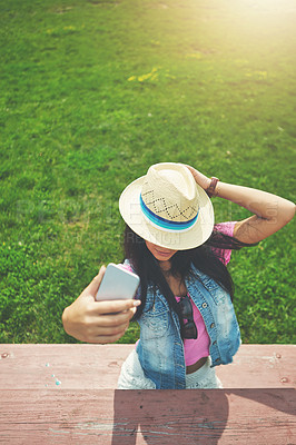 Buy stock photo Shot of a young woman spending a day in the park