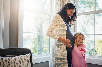 Buy stock photo Pregnant, woman and daughter with listening to tummy for baby kick, excited for newborn and curious with smile in home. Mother, pregnancy and happy girl with ear on stomach for bonding, care and love