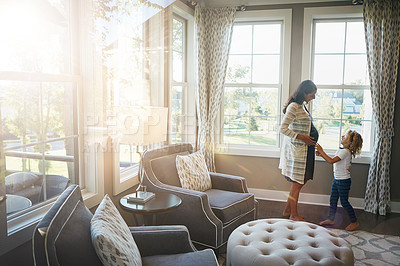 Buy stock photo Shot of a pregnant woman bonding with her little son at home