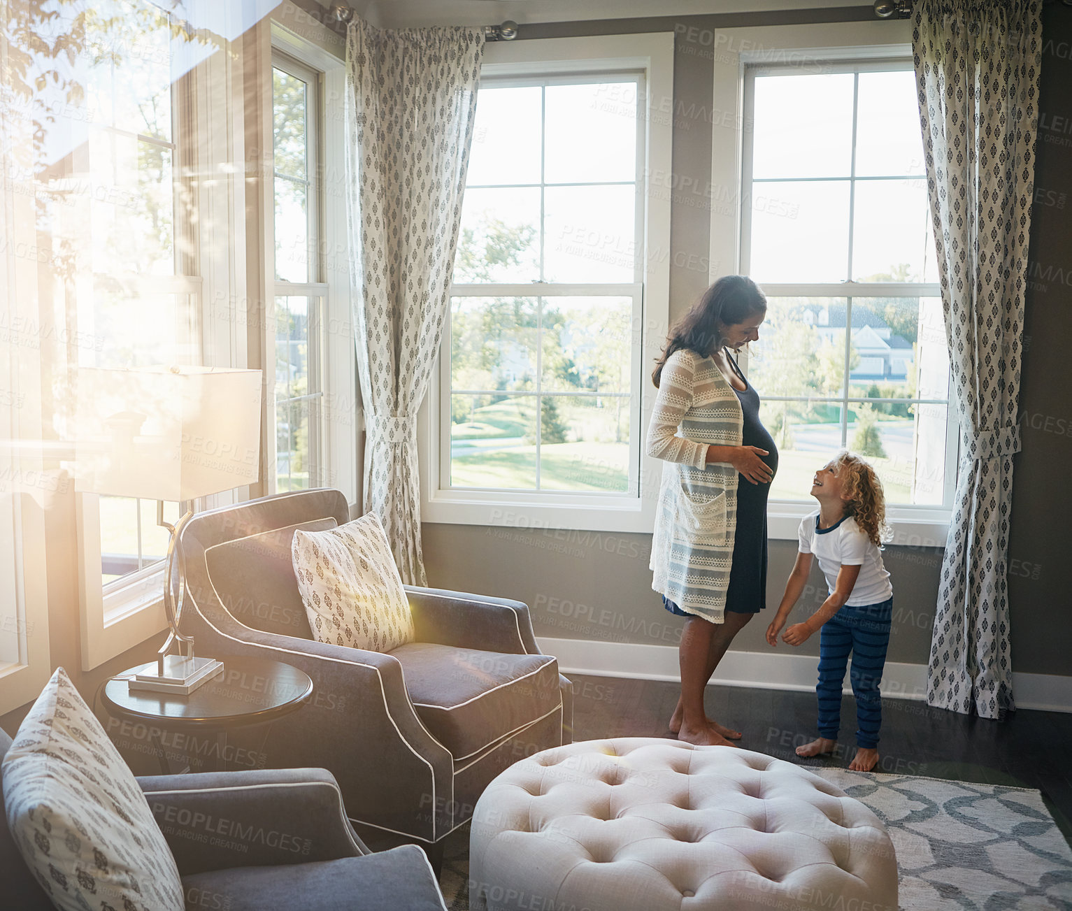 Buy stock photo Conversation, laughing and pregnant woman with son in living room of home for bonding or fun. Funny, love or pregnancy with boy child and excited parent in apartment for development or family