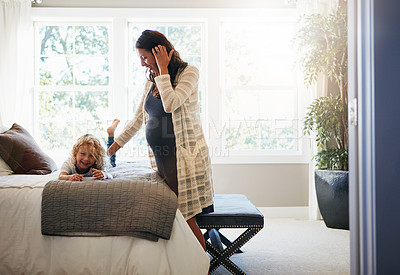 Buy stock photo Shot of a pregnant woman bonding with her little son at home