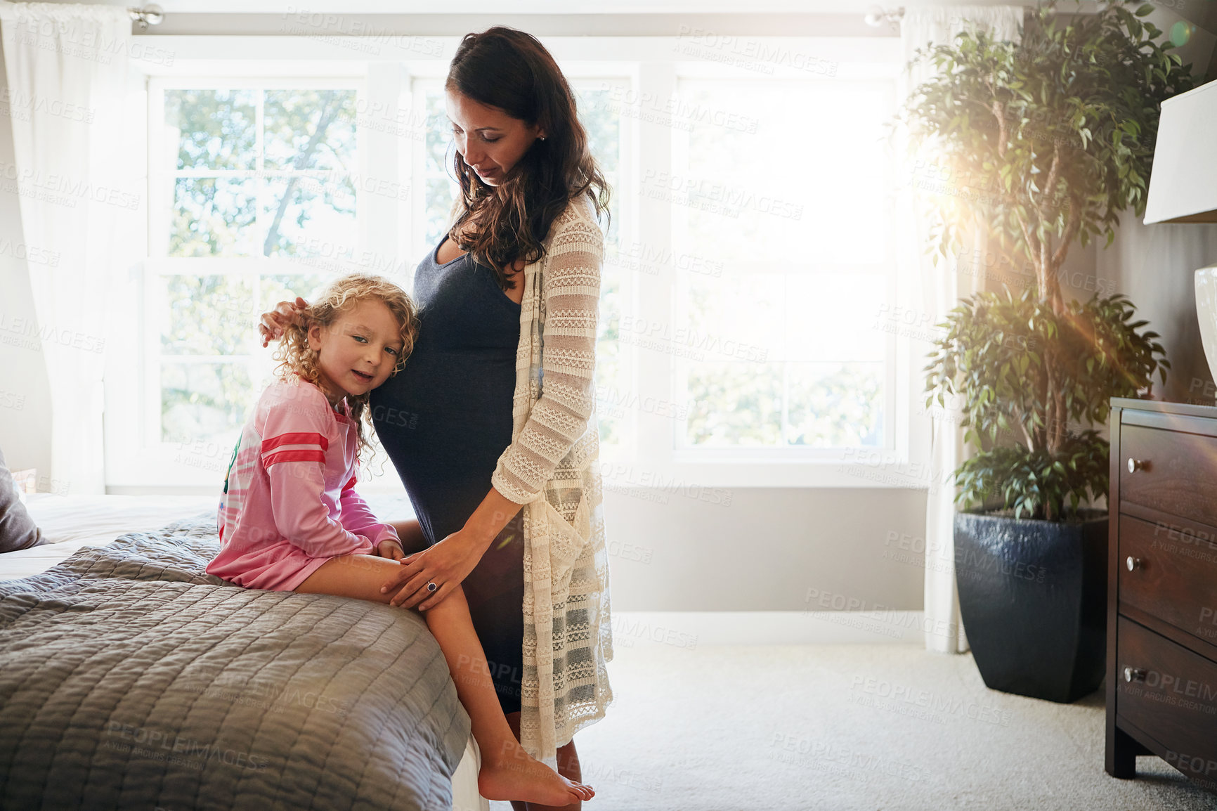 Buy stock photo Bed, pregnant woman and kid listen to stomach, abdomen or girl hearing heartbeat, moving baby or family development. Mom, home bedroom and young child curious over pregnancy, maternity or life growth