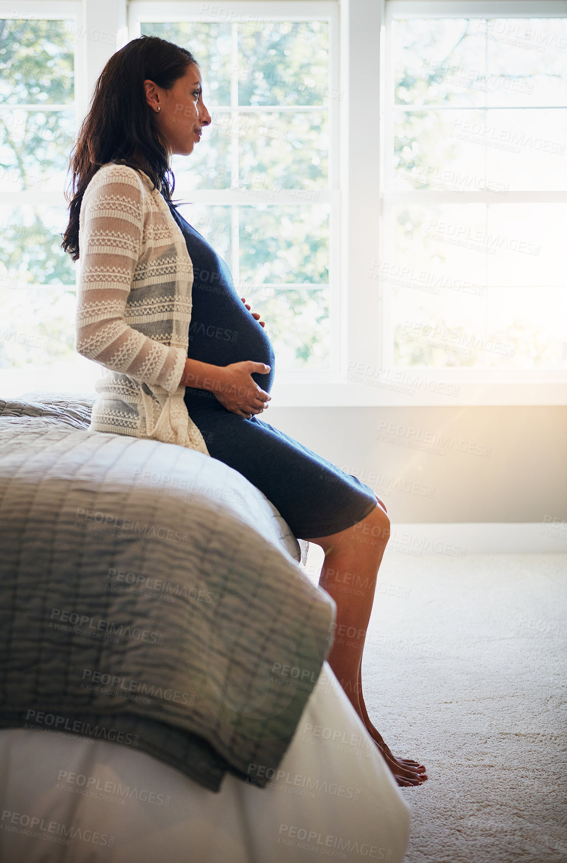 Buy stock photo Shot of a pregnant woman relaxing at home