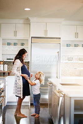 Buy stock photo Shot of a pregnant woman bonding with her little son at home