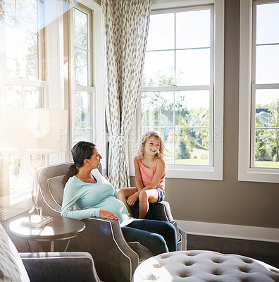 Buy stock photo Shot of a pregnant woman spending time with her daughter at home