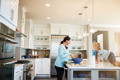 Buy stock photo Mom, boy and pregnant in kitchen with baking in smile for bonding, love and support for child development. Parent, family and happy at home with cookies for fun, enjoy and relax together for memories