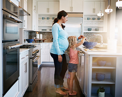 Buy stock photo Mother, girl and cookies or helping with baking in kitchen for learning, bonding and fun in home with sunlight. Family, pregnant woman and child with cooking dessert, cake and sweet snack in bowl