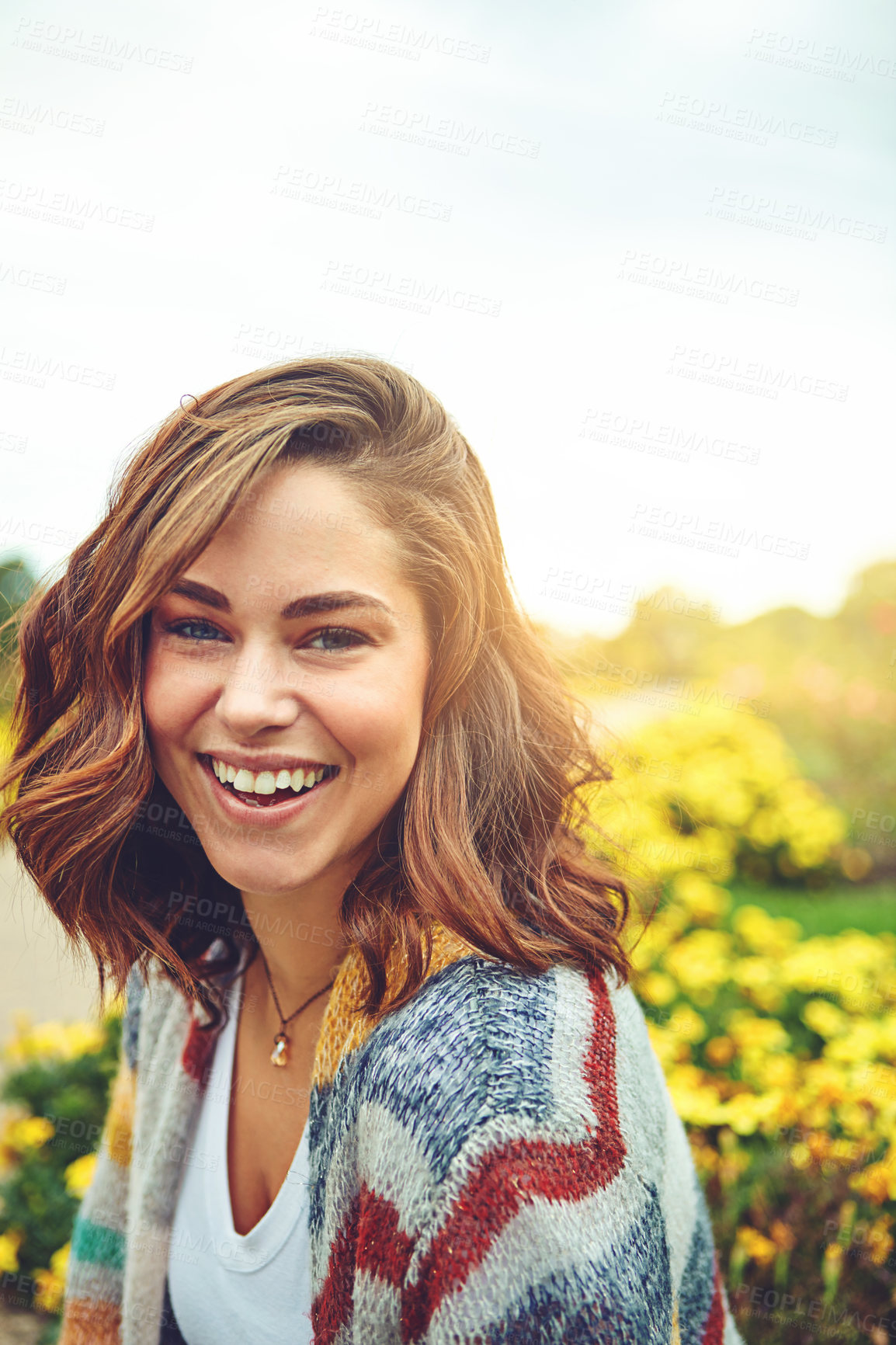 Buy stock photo Woman, portrait and flowers with smile in nature or autumn environment, countryside or outdoor. Female person, face and floral daisies in sunshine with happiness for England trip, meadow or holiday