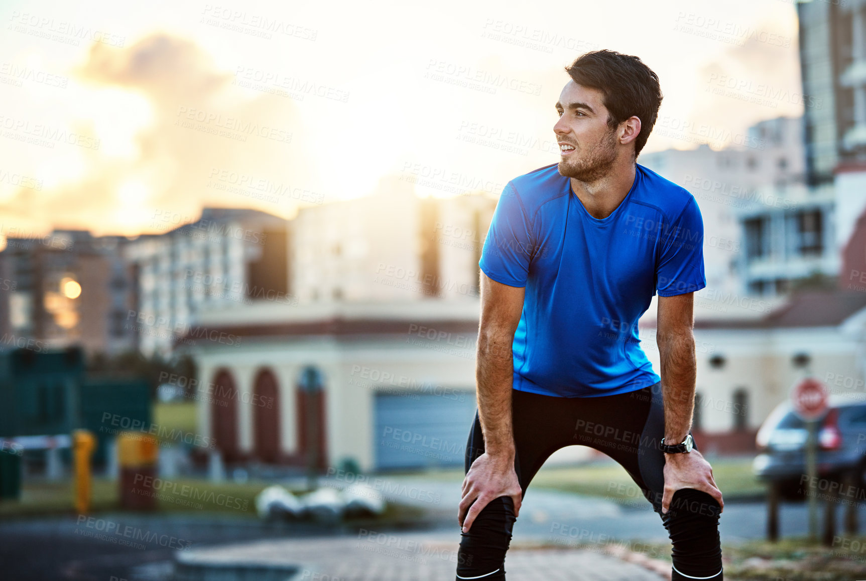 Buy stock photo Shot of a handsome young man exercising outdoors