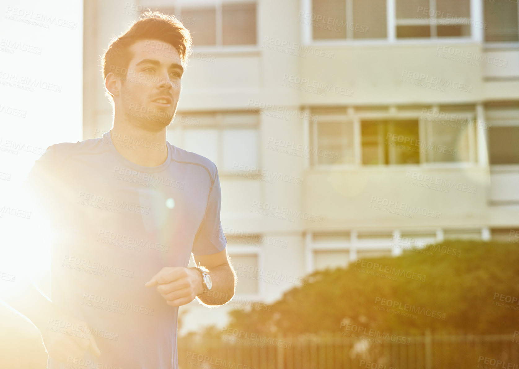 Buy stock photo Shot of a handsome young man exercising outdoors